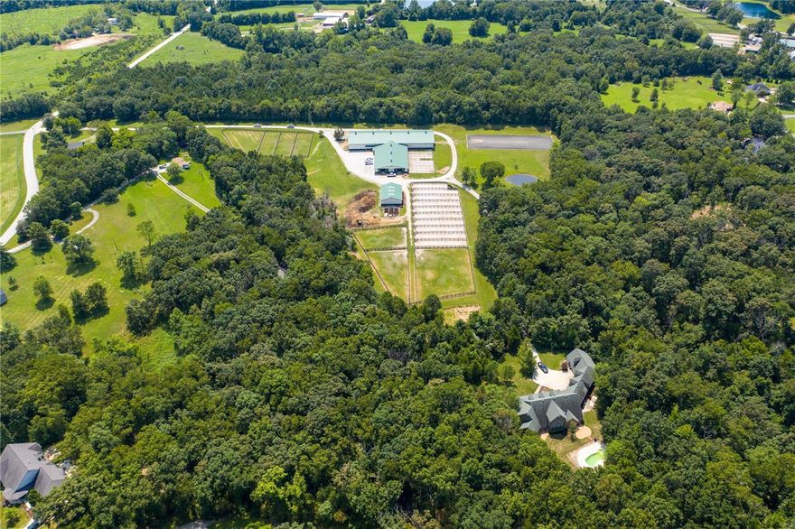 If horses are your passion, look no further. Currently used as a commercial dressage training and boarding facility, this equestrian center presents so many options. From a private estate or a commercial facility, this beautiful farm is like no other. 22 acres total between 3 parcels that are being sold together for 3.4 million total.  A 22 stall Morton Building barn of which 10 have attached runs, adjoins an attached regulation size indoor riding arena. The barn is truly 1st class w/ 2 wash bays, temperature controlled tack room, 2 bathrooms & a large lounge w/ view of indoor arena  In addition there is a 2nd smaller barn used for hay, shavings, equipment storage & 3 addl stalls. There are 10 dry lots, 7 pastures, regulation outdoor arena & small pond. To the rear of property, down a very private drive, is a beautiful 6,000 sq ft home w/ 5 car garage, inground pool, 1st fl master, total of 4 bedrooms, 4 full/3 half baths. Smaller 2nd home as well. Duplicate listing 22000202