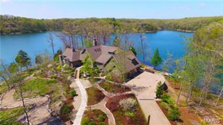 Looking for a weekend getaway/corporate retreat? Here's a secluded manor w/breathtaking views of woods & water from every window! Nestled on the point of a private peninsula on the largest lake at Innsbrook, this majestic 5-bedroom, 1.5 story w/5 full & 2 half baths + a stunning open floorplan is just the beginning. Inside, you'll marvel at the gleaming hardwood floors & extensive millwork all leading to a huge great room featuring a wood-lined cathedral ceiling w/exposed beams reaching above the towering stone fireplace. The chef in you will delight at the upscale gourmet kitchen featuring 2 dishwashers, Thermador exhaust system, Subzero fridge, designer Kohler sinks, Viking professional stove w/pot filler & impressive granite counters + butler pantry & wet bar. Must see master suite w/cathedral ceiling, fireplace, luxurious private bath & 2 walk-outs to private patio w/hot tub & outside fireplace. Expansive finish LL adds large family, workout & media room + more! Private dock too!