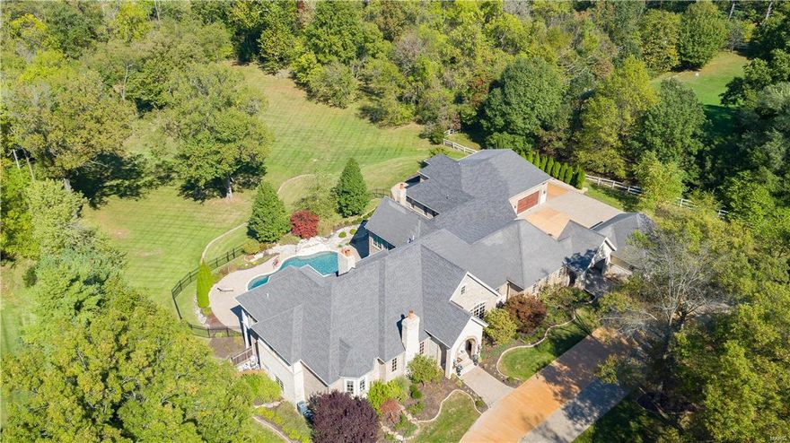 Spectacular 7 Bds/11 Bths (8F/3H) home w/10,800+ sqft of living spc, on 3+ acres. Stunning 10’ front door; elegant Dining Rm w/crown molding, Office/Den w/built-ins & marble frplc; Master Ste w/balcony & luxury Bth w/coffee bar/bev cooler & walk-in closet; 2nd Bd w/Bth; Great Rm w/tray ceiling, stone frplc & wall of windows. Gourmet Kitchen w/custom cabinets, granite, island, Wolf Range, indoor grill; 2 extra ovens, 2 dishwashers, 2 fridges, freezer drawers, pantry & 2 butler pantries! Breakfast Rm & Hearth Rm w/custom ceiling & stone frplc. Family Rm & 2 add’l Bds w/Bth, add’l Guest Ste w/Sitting Rm & Kitchenette; 2 Stylish Powder Rms & Laundry Rm. W/O LL w/Game Rm, Family Rm w/marble frplc, wet bar, Exercise Rm, Media Rm, 2 add’l Bds & Bths. Highlights: 10’ ceilings, wood doors, audio system, alarm, sprinklers, central vac & 6 car garage. Relax outside & enjoy the large yard. Perfect home for entertaining! Great location ~ close to shops, parks & hwys.