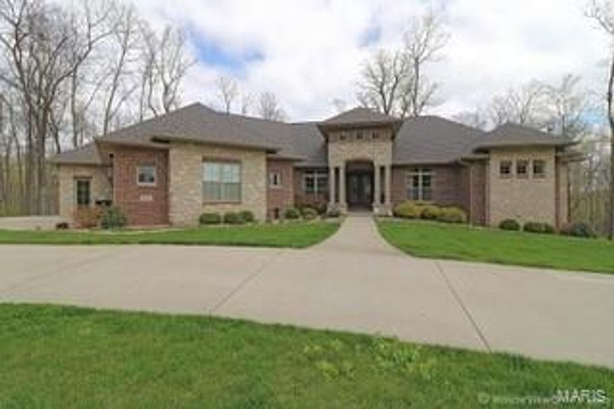 SO MUCH DETAIL! Designed by the home owner and a local interior designer, when you walk through the doors you feel the comfort with a flair of elegance! The beautiful kitchen is designed for cooking and entertaining with a subzero refrigerator, four specialized cook ovens, a big walk-in pantry, and a huge marble island to accommodate large gatherings. The master suite has it's own screened porch with BREATHTAKING views from the back! The master bath has marble floors, a 7ft Koehler jetted tub, and an expansive walk-in shower with steam option. A huge master closet has spectacular built-ins for storage encasing a washer and dryer just for the master. The walk-out lower level is sure to impress with a spacious great room, custom built-in bar, craft room and a private work out room and much more. The home is hi-tech/hi-efficiency for easy living with HVAC systems that can be gas or electric, humidifier, water softener and an alarm system with video. THIS HOUSE IS SPECIAL!