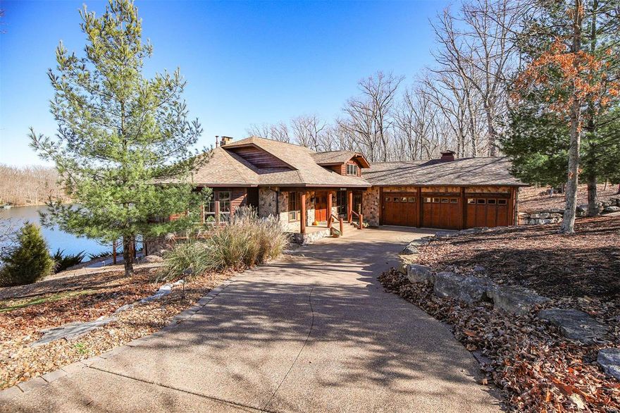 Jaws will drop at the sight of this majestic lakeside estate, covered in wood from top to bottom, a luxury lodge on Alpine Lake.  The soaring ceilings coupled with the corner stone fireplace towers over the great room, drawing your attention to the large windows and a picture perfect view. Family is never far away in this home with its enviable, completely open floor plan. A gourmet kitchen overlooks the great room and features a breakfast bar, custom cabinets and granite counter tops. The entire home is finished with logs, cedar and stone, giving it a true "lake lodge" feel.  Every room was professionally decorated to be warm and inviting.  
Other features of the home include a wine cellar, elevator from the great room to the lower level, glassed in four seasons room, screened porch, newer decks. The walkway from the lower level leads you to a flagstone patio featuring a stone wall in the backdrop coupled with a scenic view of Alpine Lake.  Home is offered with most of the furniture. Additional Rooms: Mud Room