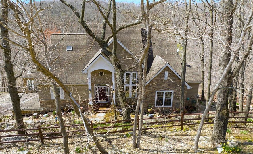 1.5 story home on secluded 4 1/2 acres in highly desired LaSalle Woods located in Wildwood.  Serene woodsy setting, lovely flagstone walk ways & landscaped property is a cozy hillside retreat.  2 story foyer opens to great rm w/cathedral ceiling & floor to ceiling stone FP & wall of floor to ceiling windows overlook peaceful private view.  Spacious kitchen/breakfast rm offers center island, SS appliances, new electric cooktop & large breakfast bar, walk-in pantry, desk.  Off kitchen-sunroom w/wood stove , screened porch & nice sz laundry rm.  ML Master Bd has loft & private deck looks out to stunning scenery & inground pool & has luxury bath w/heated floors, custom walk-in closet.  Bed 2 & Full Bath on ML.  UL- office & 3rd Bed w/private composite deck.  W/O LL - media rm w/stone, liv rm w/2nd stone FP, 4th bed w/triple closets, bonus rm, 3rd full bath, storage.  2 car oversz garage & mudroom.  Gorgeous inground pool & level fenced area w/playhouse.  Chicken coop & stone firepit too! Additional Rooms: Sun Room
