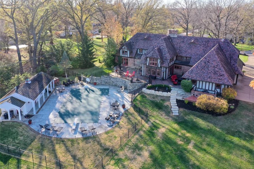 Fully improved Executive home on a premier street in the heart of Frontenac. Approx. 7,000 square feet of living area with main level primary suite featuring renovated bathroom and room-sized organized closet. Reclaimed pine flooring with radiant heat, and spectacular vaulted great room with antique pine ceiling. Large level 1.5 acre lot with pebble sheen pool and fully outfitted pool house. Ideally suited for outdoor entertaining with expansive patios. Updated kitchen features Viking and SubZero appliances, and custom glass front cabinetry. Four bedrooms + exercise room and home theater/Golf practice studio on 2nd level, with it's own separate stairwell from the exterior for the ideal in-law or au-pair quarters. Finished lower level includes billiard and family rooms as well as custom wine room. Four car garage parking with expansive circle drive. Clay tile roof, copper gutters, concrete and paver driveway. True one-of-a-kind retreat. Near highway access, shopping, and dining.