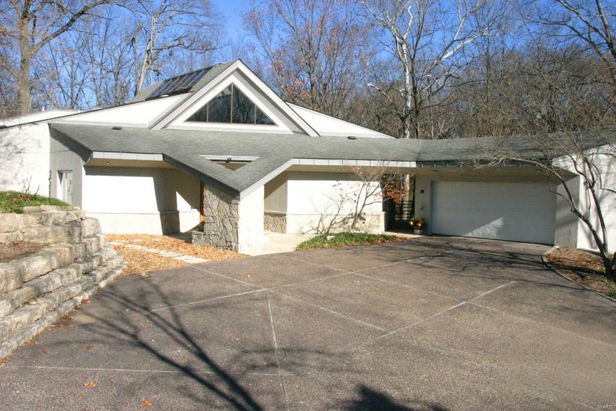 Rare opportunity to live in one of Kirkwood's most exclusive areas. This contemporary, 3 bed/3.5 bath custom home nestled on wooded 1+ acre lot overlooks Sugar Creek. Very private, one-level living w/ luxury amenities. Street developed on one of the last large parcels of land in Kirkwood. Incredible views from every room to gardens, woods, creek, & natural cliffs. Open floor plan flooded w/ tons of natural lighting that even includes a skylight. Airy great room offers a double-sided glass gas fireplace,natural flagstone floor, & plenty of windows to let the outside in. Spacious eat-in kitchen w/ built-ins. Entertaining is made easy-breezy on expansive deck. All bedrooms are en-suite & include walk-in closets, tall ceilings,& are walk-out. Master bedrm suite has bonus sitting rm where the deer, turkey & birds come directly to your door. Don't forget to note the side yard & cool garages. In the spring, delight in the view of the bluebells, woodland poppies, & bleeding hearts in gardens.