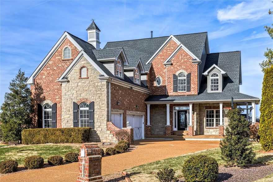 An impressive brick & stone elevation highlights the remarkable curb appeal of this spectacular Byrne-built 1.5 Sty. Wrap around front porch & extraordinary leaded glass door lead to 2-sty hardwood foyer, formal dining room with detailed trim work and stunning great room with brick & stone fireplace flanked by built-in bookcases, dramatic wall of windows & sliding glass door that opens to expansive deck that overlooks the lake & 3rd hole on the South course. Designer kitchen with 42'' white cabinetry, granite countertops, premium appliances & 10’ center island adjoins breakfast room with beamed ceiling & fireplace. Primary bedroom suite radiates warmth with a stone fireplace, luxury bath with shower spa & freestanding tub & access to deck. Hardwood floors continue to the 2nd level with 3 additional bedrooms, 1 with ensuite bath & 2 with Jack n’ Jill bath, & bonus room with full bath. Lower Level includes recreation room with wet bar & media room plus office, 5th bedroom & full bath.