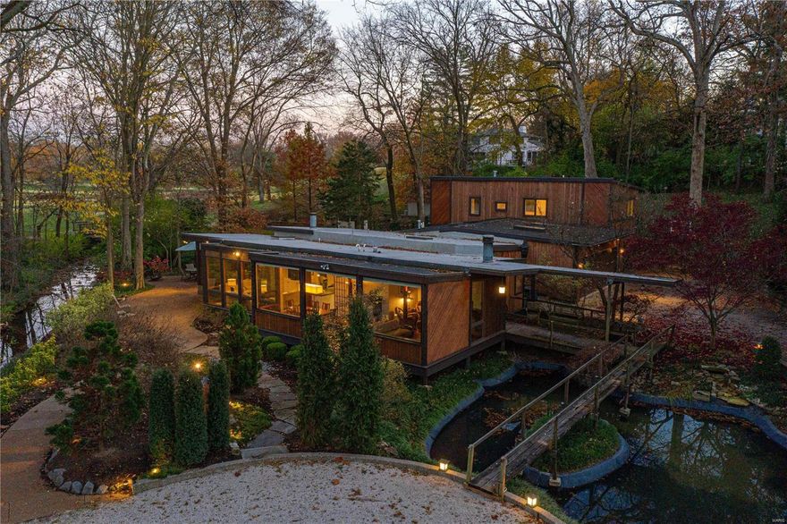 This is an exciting opportunity to purchase what was once esteemed architect, Harris Armstrong’s, former studio and offices. Over the years it has been expanded and transformed into a residence. A koi pond greets you as you venture towards the front door. The living room features a fireplace and is open to the dining room & kitchen. An abundance of windows throughout look onto the private yard, woods, and golf course beyond. There is an office, den & family room. Off of the family room is an expansive screened porch that leads to the terrace. The primary bedroom is spacious with doors that also lead to the terrace, a woodburning fireplace, jacuzzi tub, walk-in closet & an expansive bathroom with dual sink vanity. The main level has 2 more bedrooms, a recreation room that could be an additional bedroom, wine room & hobby shop. The upper area has a sitting room & 2 en-suite bedrooms. 2-car garage with epoxy painted floor & storage cabinets. Additional Rooms: Sun Room