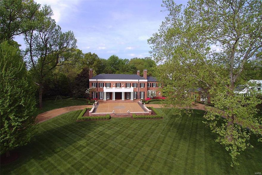 NEW PRICE-$340,000 OFF ORIGINAL PRICE! One of St. Louis’s signature homes designed by George Hellmuth situated on 1.6 acres with lovely terraces, pool & landscaping. Exquisitely updated & maintained throughout, including kitchen & baths. Large rooms with exceptional details, seven fireplaces, arched entries, classic millwork, floor-to-ceiling windows, stunning circular staircase & paneled study/den with bay window. Marble kitchen & butler’s pantry with top-of-the-line appliances-Viking, Asko, Miele, SubZero, plus adjoining breakfast/family room & activity room/office with built-ins & island. Fabulous master suite with marble bath plus his & her walk-in closets. A second bedroom suite, two bedrooms with Jack & Jill bath, laundry room & breakfast bar complete the second floor. Finished lower level with family/media room, 1000-bottle wine cellar & full bath. Guest apartment with updated kitchen & bath. 3-car garage & generator. This is truly a magnificent property.