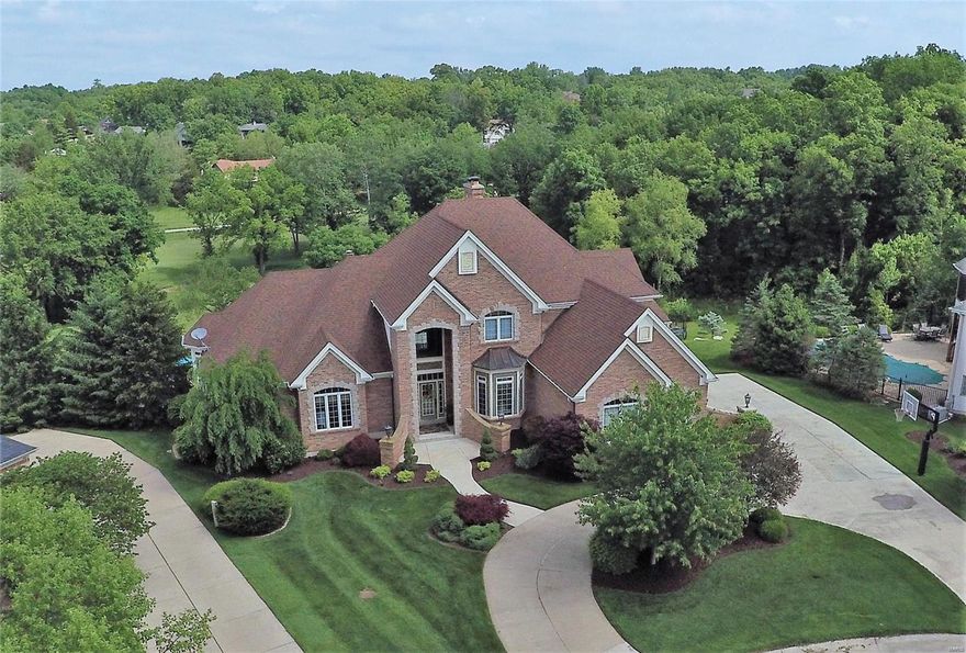 Prepare to be wowed with charm and quality at every turn. Impressive great room with soaring ceilings and a wall of windows framing scenic views of the pool and golf course.  Sophisticated gourmet kitchen boasts high end appliances, granite, center island, separate breakfast area and hearth room. Serene and spacious master suite adjoins the office with rich wood details and private coffee bar. Including an en-suite luxury bath with over sized shower, whirlpool tub, his and hers vanities and closets. The lower level includes a custom designed theater room with fireplace, wet bar, wine room, exercise room and additional bedroom. The home is a smart home including security, audio and temperature. A resort-like backyard invites relaxation from the sounds of your own waterfall, raised infinity edge pool, large patio areas and deck for outdoor dining overlooking hole 17 of the prestigious Lake Forest Golf Course.