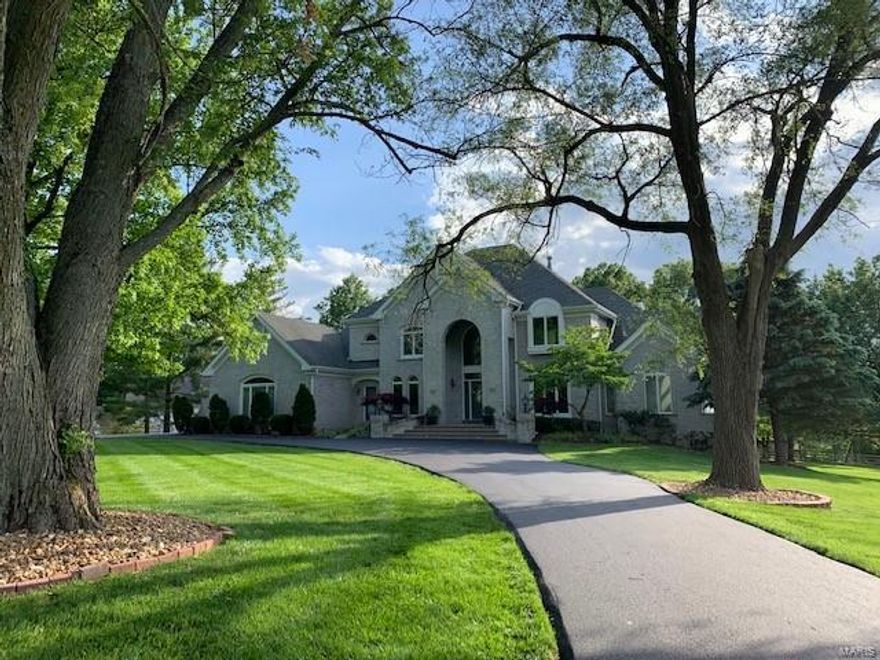 This stunning 1.5 story is nestled on a large lot full of mature trees offering privacy and lots of room for play and entertaining. Wonderful curb appeal with  full brick front elevation,  large circle drive and side entry 3 car garage.  Updated throughout this home offers so many wonderful features to include a Newer kitchen with white cabinets and a large custom island  made of cherry wood and Brazilian granite. Wood flooring, stainless appliances, gas cook top, double ovens connect to large hearth and breakfast room. The master bedroom is on the first floor with a totally remodeled master bath complete with double vanities, soaking tub, extra large shower and heated floor. Upstairs there are 3 bedrooms, 2 full baths and a bonus room with a balcony overlooking the 2 sty greatroom.  There is a first floor office with beamed ceiling.  The lower lever is a walk out and offers a rec room, 5th bedroom, full bath, theatre room and family room.  Extra rough in and bonus room as well.