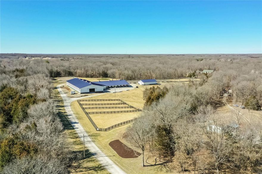 ANOTHER HUGE PRICE REDUCTION!  TIME TO MAKE AN OFFER!  Fantastic opportunity to own your very own horse farm with a 6500 sq ft owner’s home on over 22 secluded acres.  Formerly a working equestrian training center, find a 22 stall barn, regulation sized arena, viewing rm, hay barn, small pond, 7 pastures, 10 dry lots and more.  The CURRENT OWNERS HAVE INVESTED OVER $2M, painstakingly rebuilding the barns, stables and arena, leaving the interior to be designed by the next buyers.  Built in 2003, the owner’s home at the back of the property boasts a main flr master, 6 car garage and pool.  A gorgeous private property to call home or business/home conveniently located approx. 8 miles from all of the conveniences of Wentzville. Additional Rooms: Mud Room