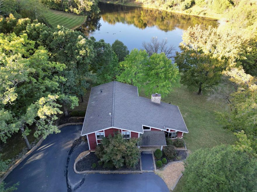 Opportunity knocks!  Rare find!  Custom home development.  Home on 3.68 acres with LAKE & sunset views!  Serene, park-like setting with spectacular views of the stars at night. Enjoy the scenery of the lake & wildlife from the deck, kitchen, breakfast room, family room & primary bedroom. Great location-about 3 miles from Wildwood Town Center off Highway 100.  Spectrum high speed internet just installed in subdivision!  2-story with 3 spacious bedrooms, 2.5 bathrooms & finished walkout basement.  Great room with vaulted ceiling, wood beams & 2-story stone fireplace. Kitchen with generous cabinetry, solid surface countertops, garden window, smooth cooktop oven. Breakfast room with door that opens to the backyard deck. Main floor laundry. Zoned HVAC. Circle drive leads to the front door. Two car side entry garage. Andersen windows. Grocery stores, restaurants, walking & bike trails, dog park, picnic areas with pavilions & playgrounds are all conveniently located.  Meticulously maintained.