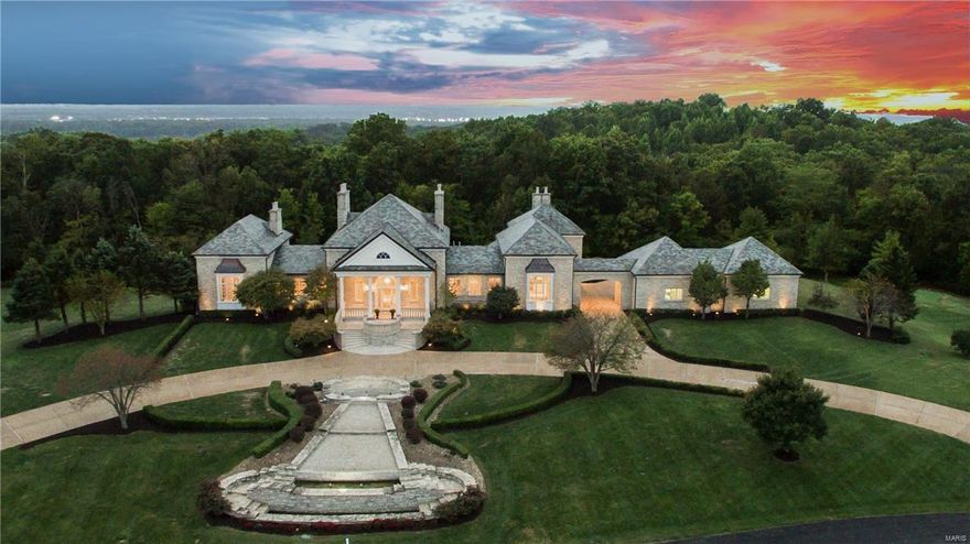 Magnificent estate owned by the Whittaker Family! Designed by renowned architect, Timothy Busse – spectacular residence features over 10,000 square feet of living space on 4.3 acres with uncompromised quality throughout. Full limestone elevation, copper gutters, slate roof and ten full masonry fireplaces are just the beginning. Stunning foyer highlighted by soaring columns & domed ceiling leads to elegant dining room & spectacular great room with atrium doors that open to limestone veranda. Kitchen adjoins octagonal breakfast room with vaulted maple-lined ceiling & light-filled family room with limestone fireplace. Main floor master suite showcases custom built-ins, beautifully appointed bath & library-paneled study. Incredible walk-out Lower Level features recreation room with wet bar, 3 additional bedroom suites & wine cellar. Impeccably landscaped, with porte cochere & 4-car garage. Located in a gated enclave of custom-built homes surrounded by Whitmoor Country Club grounds.