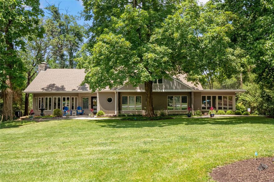 A true gem and restful retreat masterfully completed for today's lifestyle.Mature landscape and nature surrounds the exterior of this modern and elegant home.Once you've arrived on property and step inside this over 4500 square feet of open concept transitional living space you know you have arrived somewhere very unique and special. Gorgeous walls of windows surrounding the space visually bring the outdoors in! Incredible entertaining home with an open concept living room featuring fireplace, dining room and gorgeous chef's kitchen and beautiful hardwood floors.Step directly outside onto an enormous private and serene covered outdoor living space surrounded by your 1.22 acre wooded view.Main floor primary bedroom suite has a private sitting room,amenity bar with wine cooler and spacious master bathroom featuring freestanding tub and large separate shower. You will find 3 additional large bedrooms upstairs, one with ensuite and private balcony, comfy and up2date LL plus a 3-car garage! Additional Rooms: Mud Room