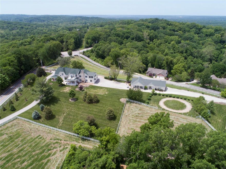 Fabulous one of a kind equestrian estate or car buff with the indoor riding arena and barn on 12+/- acres. Property includes a 60' x 115' indoor riding arena w/5-stall barn, tack area, & 3 pastures. Two stalls are 12'x12.5', two are 10'x12.5', and one is 12.5'x14'. Sit by the outdoor stone fireplace and take in the spectacular views of the valley. Come inside to find an exquisitely updated kitchen designed for the ultimate gourmet chef with 2 custom islands, granite counter tops, sub-zero refrigerator, dual dishwashers, industrial propane range, and tile floors. Upstairs master suite w/beautifully updated bath w/steam shower, heated floors, and heated towel bars. This outstanding home has been completely renovated and professionally decorated. A totally renovated guest house with 2 baths and a 2 car garage that sits adjacent to the main house and is equipped with a whole house generator that supplies emergency electric to the guest house and barn. Truly a unique property! Must see!