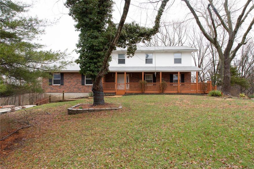 Secluded, private home with large wrap-around porch to enjoy the wildlife. Drive up to this home through the private gate and you will see that this 5 bedroom, 3.5 bath home is a diamond in the rough with a rare opportunity to get away from the hustle and bustle only 5 minutes from Manchester. There are approximately 2+ of the 16 acres are flat for your horse. Main floor has formal living and dining rooms and a sunroom off the large eat-in kitchen. The kitchen opens to the family room with fireplace. A huge bonus room on the main level beds to be converted into a master suite, but could also be used any way your family needs! Lower level is a walk-out and with a kitchen and bath shows potential for a great monther-in-law suite or apartment. Large two-car garage tucks under the house. Tons of mature trees makes this a retreat and a place to call home.