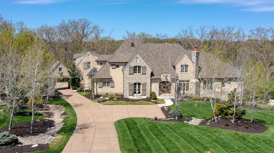 Must see in person to appreciate!Welcome to this Colorado-inspired 5BD/8BA with total living space of 9,200 SF. A striking property composed with understated elegance in tumbled stone, stained brick and plaster, rough hewn beams, faux finishes, exotic wrought ironwork, vaulted ceilings & distressed hardwoods wide plank hardwoods. This is a one-of-a-kind home with an  open unique floorplan 4-car garage & porte-cochere, backing to wooded acreage. State of the art systems including Geothermal heating & cooling. Great Room detailing includes floor-to ceiling custom stone fp.  Open kitchen outfitted w/gas 4-burner Blue Star Oven, griddle, grill & 1.5 ovens, top tier appliances and Carrera marble. Main level Master w 2 organized closets & spa inspired bath with heated stone floors and steam shower. 4 BR suites on 2nd level. Walkout Lower Level, above grade, w/exercise room, kitchen, full bath & changing room for pool home also ready for elevator. Must see this beauty on Upper Warson.