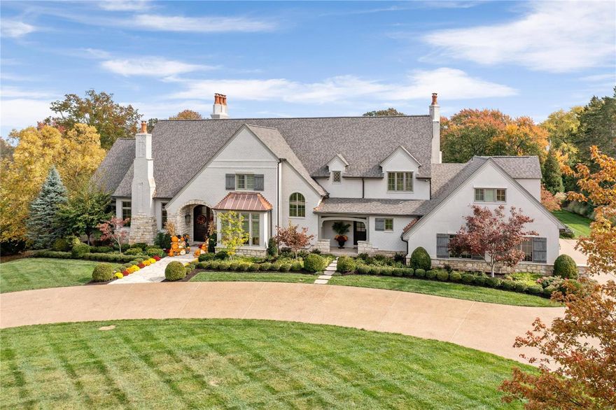 This European-style Estate home embodies timeless architecture, uniting brick, stone, and stucco. The travertine marble foyer leads to a private study with a stone fireplace and custom built-ins, an elegant dining room, and a great room with hand-hewn beams and a floor-to-ceiling fireplace. The designer kitchen features quartz countertops and commercial-grade appliances, adjoining a sunlit breakfast room and a vaulted hearth room with a soaring fireplace. The coffered master bedroom suite offers a stone fireplace, a bow window, and a marble bath. Front and rear staircases provide access to four ensuite bedrooms, a bonus room, and second-floor laundry. The lower level includes a recreation room with a bar and wine cellar, game room with fireplace, media room, bonus room, workout room, and a full bath. On a 3-acre lot, the property features an outdoor living room with a grill and fireplace, a pool house with a bar, and a resort-style pool amidst landscaped gardens. This is Home. Additional Rooms: Wine Cellar