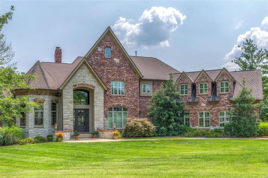 An impressive brick & stone elevation highlights the remarkable curb appeal of this spectacular 1.5-sty Estate home! Dramatic 2-sty foyer leads to private study with natural pine paneling & built-in work center, elegant dining room & stunning great room with 2-sty bay window, wet bar & floor-to-ceiling stone fireplace flanked by bookcases. Designer kitchen featuring 42” pine cabinetry, commercial grade appliances & 11’ center island adjoins breakfast room with wide bay window & vaulted hearth room highlighted by stone fireplace. Sumptuous master bedroom suite offers a relaxing retreat with 2 walk-in closets & marble bath with Jacuzzi. The 2nd floor extends the living quarters with 3 additional bedroom suites & bonus room. Lower Level features recreation room with fireplace, billiard room & 2nd kitchen plus workout room, 5th bedroom suite & pool bath. Outdoor entertaining area includes resort style pool with spa surrounded by landscaped gardens, terrace with fireplace & expansive deck.