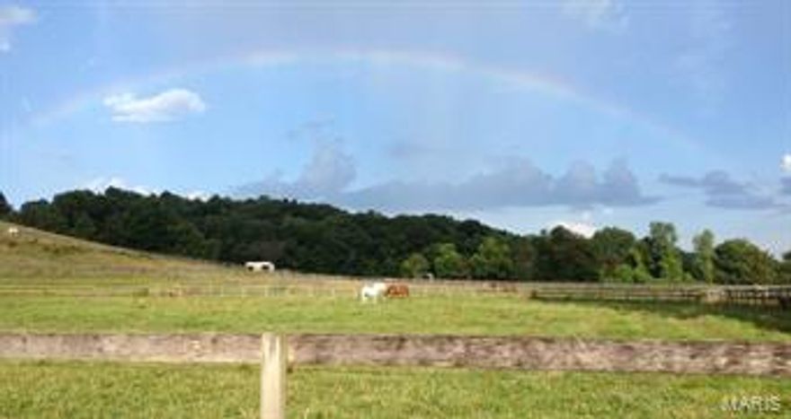 Gorgeous 52+ acre equestrian property right here in St. Louis County.  MANY POSSIBLE USES!  Keep it as is; a private estate, and small boarding ranch. EXPAND THE HORSE BOARDING AND TRAINING BUSINESS!!  Develop small mini ranches for horse lovers, with central indoor and outdoor riding rings.  Or just enjoy the beauty of it, while it increases in value daily.  This property has a rare spring and stream flowing through it. Plus several ponds and a small lake. The horse facilities include a 160' x 76' indoor arena, an outdoor arena, 3 barns with 18 stalls, multiple turn-out pasture areas, a large round pen, a 5/8 mile training track, a great, natural jump area, and abundant trails. Property includes 5+ acres zoned commercial,  which contain some large storage sheds.  The large home on the property has 5 bedrooms and 8 bathrooms. Part of it is an authentic 1800s log home. See this beautiful and amazing property soon.