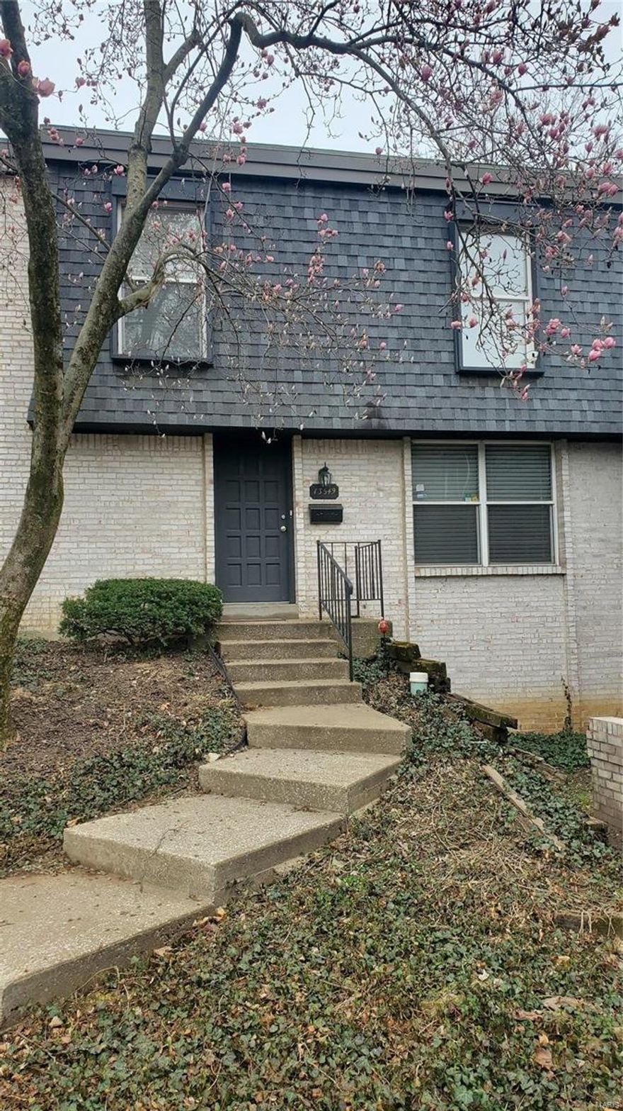 Large, 4 bedroom, 3 bathroom, 3 level townhome in Central location!  Bright kitchen with stainless appliances and granite counters.  Kitchen opens to a massive deck that overlooks peaceful wooded area!  Deck is 20 x 25!  Two family living areas and bonus 4th bedroom or office in the full finished, walkout basement!  Spacious laundry room.  Ample space in the 2 car covered parking under the deck.  Quiet, peaceful location and easy access to 141, 270, Airport, and restaraunts and shopping!  Come see!  Priced to sell!