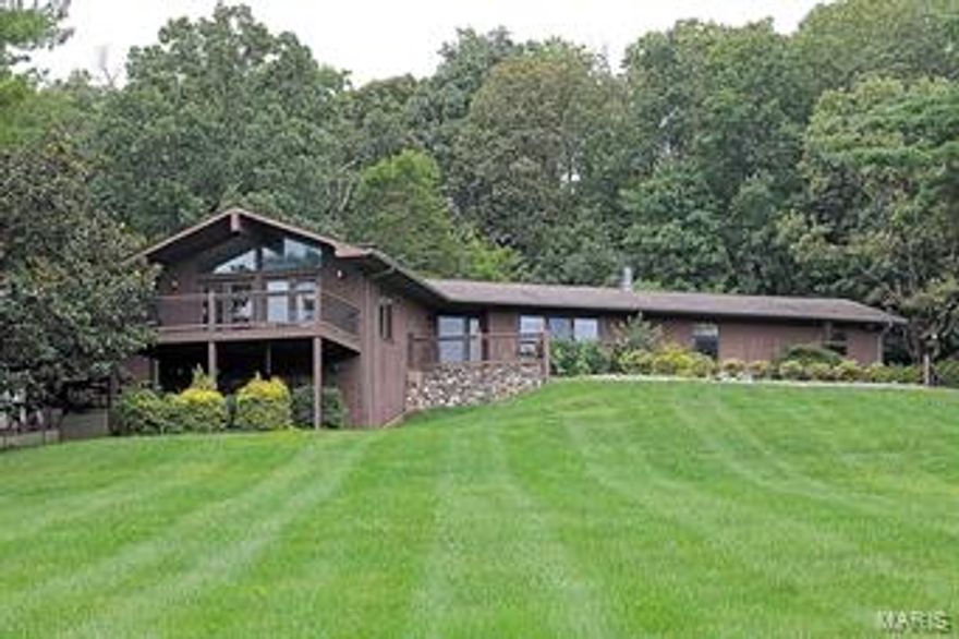 This unique, custom built home sits at the apex of 2 acres with sweeping views of a beautiful and desirable neighborhood.  It features composite decks and balconies with multiple levels.  The home boasts 5 bedrooms, 3 1/2 baths, with kitchen and great room that have been updated within the last 3 years.  This home features a larger river rock fireplace on one entire wall of the great room which curves down to the bottom level where a pit area creates an intimate space for those winter nights in front of the fireplace.  The master bedroom walks directly out to the large in-ground pool, as does access from the kitchen hallway.  This perfect outdoor entertainment space also features a large fireplace for those fall s’more nights as well as a full stainless outdoor kitchen.  With a band of woodland beyond the pool, this is a very private entertaining area.  Outbuildings include a pool house and detached 2 car garage. T Additional Rooms: Wine Cellar