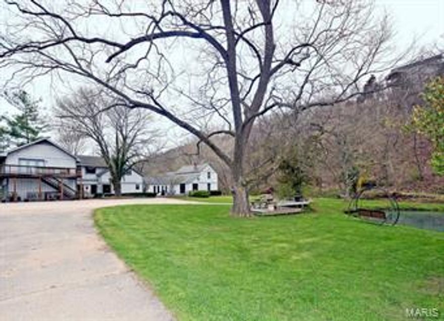 Gorgeous 52 plus acre equestrian property right here in St. Louis County.  MANY POSSIBLE USES!. Keep it as is; a private estate, and small boarding ranch.  Develop small mini ranchs, with central indoor and outdoor riding rings. EXPAND THE BOARDING AND TRAINING BUSINESS.  Or just enjoy the beauty of it, while it increases in value daily.  This property has a rare spring and stream flowing through it. Plus several ponds and a small lake. The horse facilities include 3 barns with 18 stalls, multiple turn-out pasture areas, A 160' BY 76' INDOOR ARENA, an outdoor arena,  a large round pen,  a 5/8 mile training track, a great, natural jump area, and abundant trails. Property includes 5+ acres zoned commercial,  which contain some large storage sheds. The large home on the property has 5 bedrooms and 8 bathrooms.  Part of it is an authentic 1800's log home. See this amazing property soon.