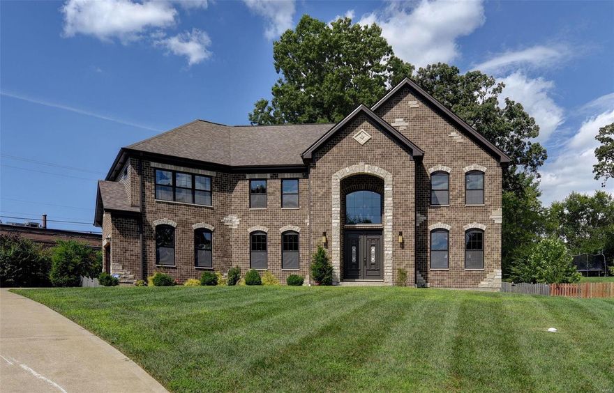 Welcome to stunning!  This home has it all-grand curb appeal, high-end finishes, plenty of space, finished lower level with kitchen…  wow!  Just 4 years young, this home is move in ready. Located on a quiet culdesac lot, the home draws you in with a brick & stone elevation and professional landscaping.  Stunning open 2 story entry foyer with sweeping staircase & adjacent formal living & dining rms w/custom wainscoting.  Prof kitchen w/ exotic granite, custom cabinetry, SS appliances, adjacent butler’s pantry area with beverage fridges, wine rack & storage.  Family room with fireplace is surrounded by windows.  The second floor offers large open loft area, laundry room, spacious bedrooms & large closets.  The owner’s retreat is exactly that – a true retreat!  So spacious, 2 large walk-in closets and a dreamy master bath.  The LL is finished with 5th bedroom, full bath, tons of rec space & full kitchen.  Lots of storage space too.  Covered outdoor living area.