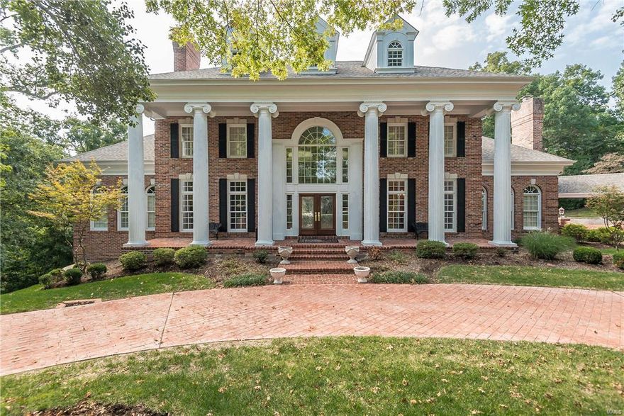 Stunning all brick 1.5 Story with 5 car garage nestled on 3.1 acres. 2 Story foyer w/ dramatic staircase & porcelain floors flanked by the den with built-in bookcases, fireplace & coffered ceiling, beautiful dining room with wainscoting & hardwood floors. Grand Hall boasts wall of windows, french doors lead to deck, fireplace & wet bar. Gourmet kitchen features over-sized island, Thermador 4 burner gas cooktop & hood, 2 GE Profile wall ovens, Sub-Zero fridge, flows into the hearth room. Main floor master suite is exquisite with his & hers walk-in closets, built-in bookcase, coffered ceiling and separate vanities, jetted tub, and a steam shower to finish your day. Upstairs offers 3 bedrooms-2 share jack-n-jill bath, 1 with ensuite bath. One more ensuite above the garage is perfect for guests. Entertain in the walk out LL finished with wet bar, surround sound, full bath, see-thru fireplace & fitness room. Beautiful plaster mouldings, plantation shutters throughout & so much more.