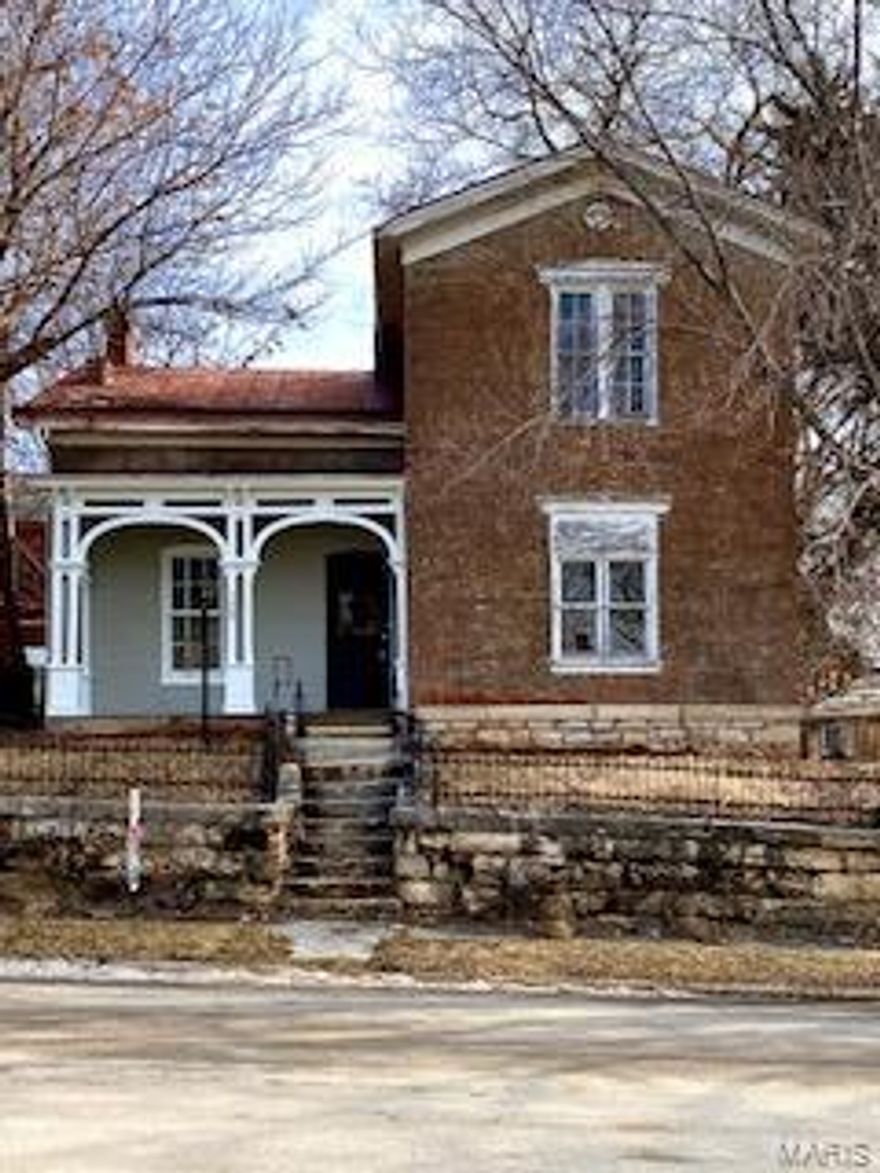 Historic home is America's Hometown!
Brick two story home located in the historic district. Main level has sitting area, living room, bedroom or office, and kitchen. Kitchen has wood cabinets, range, refrigerator. Main level bathroom has washer and dryer connections. Upstairs has three bedrooms and full bathroom with dressing area. Hardwood floors throughout house. New carpeting. Level backyard.  Detached 1 car garage and off street parking.  Call today to see this historic property.