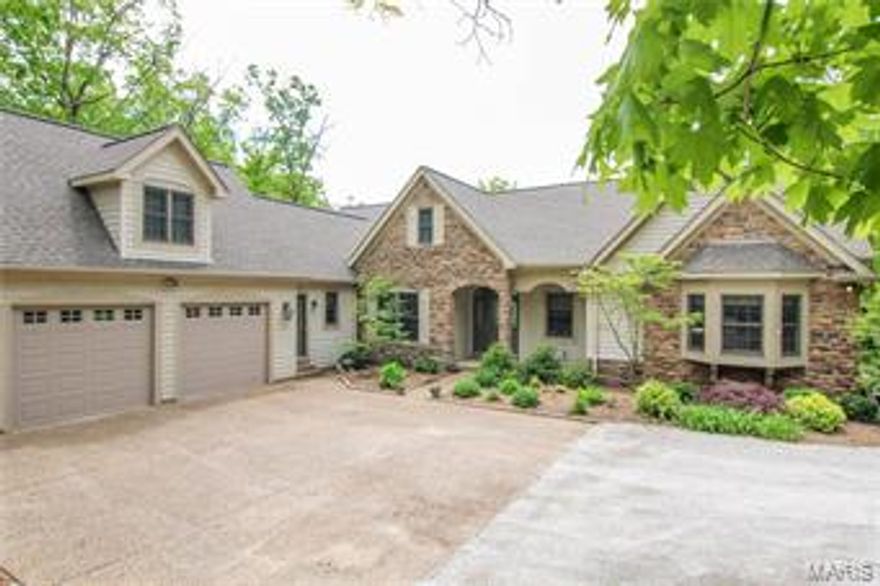 Staggering lake views, a densely wooded lot with no visible neighbors, and a large, custom-built home provide an extraordinary setting for a weekend getaway or a year-round home. With over 3 acres on Lake Alpine, the only dock on this secluded cove is yours! Every room has lake or forest views. The main level's open plan has a great room with cathedral ceiling, wood burning fireplace, and a window wall. A gourmet kitchen includes granite counter tops, central island, lake-facing breakfast bar, and casual dining area. The master bedroom has generous windows, walk-in closet, and large bathroom with corner Jacuzzi. The main floor includes a guest bedroom suite with full bath; separate dining room; laundry room; office; 3-season porch set into the woods; and a lake-view deck. The LL opens into an expansive recreation room with a mini-kitchen, bar and fire place. There are two more bedrooms, a full bath, and storage areas. The LL opens to another deck and covered outdoor dining area Additional Rooms: Sun Room