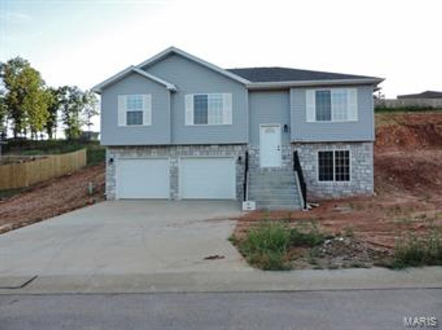 BRAND NEW HOME, MOVE IN READY!This home is located inside the city limits of St. Robert, less than 3 miles from the main gate of the Fort! This property offers an open concept floor plan with plenty of natural lighting! The main level features a spacious living room that adjoins the kitchen and dining area highlighted with ceramic tile flooring and access to the rear deck. The kitchen features custom cabinetry, center island, and sleek updated appliances. The Owner's Suite is generous and features a custom ceiling design and a private bath. Each of the additional bedrooms offer standard closets and share a spacious full bath in the hall. The lower level offers access to a large family room that's carpeted for comfort, laundry room, and the 2 stall garage,. Call your Agent today to view! C&Rs are available and should be viewed prior to making an offer. This lot has county sewer, all other utilities are City of Saint Robert.