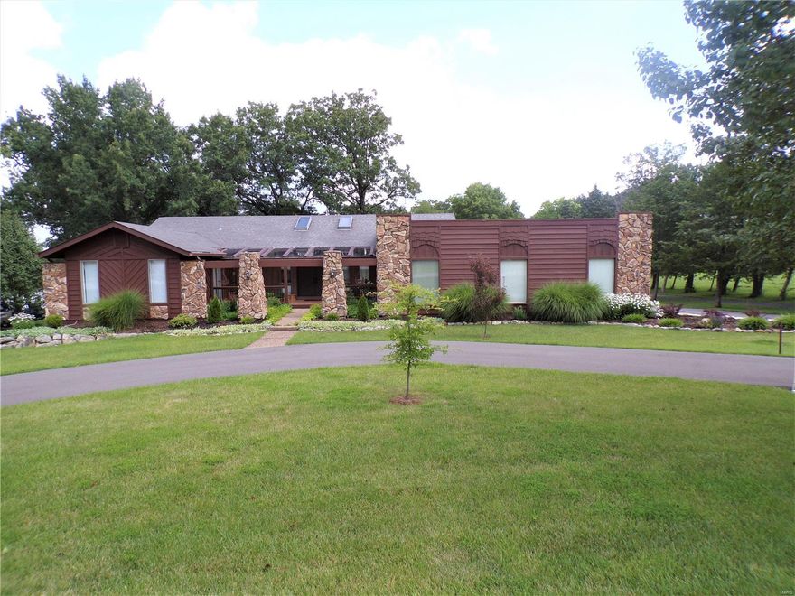 SPACIOUS CUSTOM BUILT HOME WITH LAKE VIEW PARK LIKE SETTING LOT! As you walk into to the home you will be greeted to a large great room with vaulted beam ceiling, beautiful wood burning fireplace and view of the 8 acre stocked lake. The large eat in kitchen offers plenty of counter tops, custom built cabinets, breakfast area with bay window and stainless steel appliances. The large separate dining room offers space for all your entertaining needs and there is a powder room.Master bedroom offers access to the porch to enjoy your morning coffee,large walk in closet,huge master bath.There are 2 more spacious bedrooms,one with a walk in closet along with a 2nd full hall bath. Main floor also has separate office, laundry room and a mud room that has access to the storm cellar. Lower walk out level has a huge family room,4th bedroom, 3rd full bath, oversized storage area. Outside you will find a 30x20 det.garage with elect/concr  floors,garden area, patio, 1.2 acres of beautiful landscaping, Additional Rooms: Mud Room