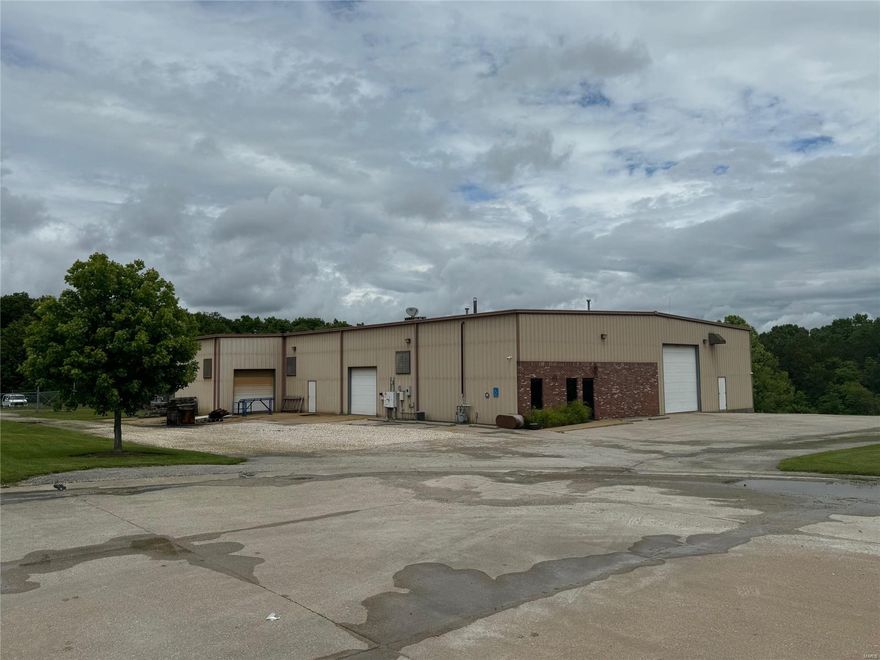 Great location in the Truesdale Industrial Park. This 8,400+ Sq. Ft. building sits on 8.7 acres that includes a stocked pond, a 1-acre fenced vehicle storage lot, and a large, paved parking lot. The building has 2 drive in entrances and 1 loading doc. There is 500 Sq ft of office space and there are 2 bathrooms. 1 bathroom is in the office area and the other bathroom is in the warehouse. The electric service has standard service as well as 3 phase x 2. The 2 different types of 3 phase services are 120/208 4 wire and 240v 3 wire. The is an onsite transformer that also provides an extra leg of service to the back of the building. This building is well equipped for your needs serviced by 8" water and 8" sewer mains, Ameren electric and a $100,000 solar panel setup that keeps your electric bill low and even provides a credit in some months. Come see this property right away. There is so much that this site offers as well as the additional acreage for expansion. Location: Industrial Park, Industrial Area