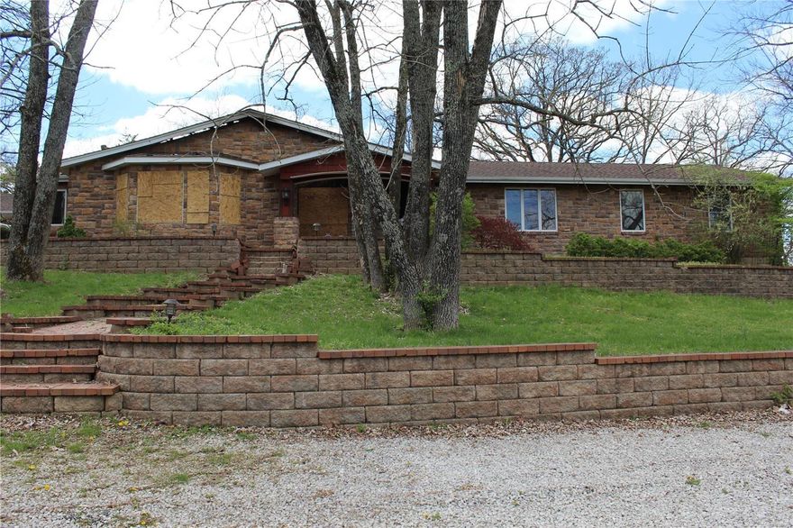 Spacious ranch home on 4.89 acres. Home needs major renovations to part of the home from fire damage.