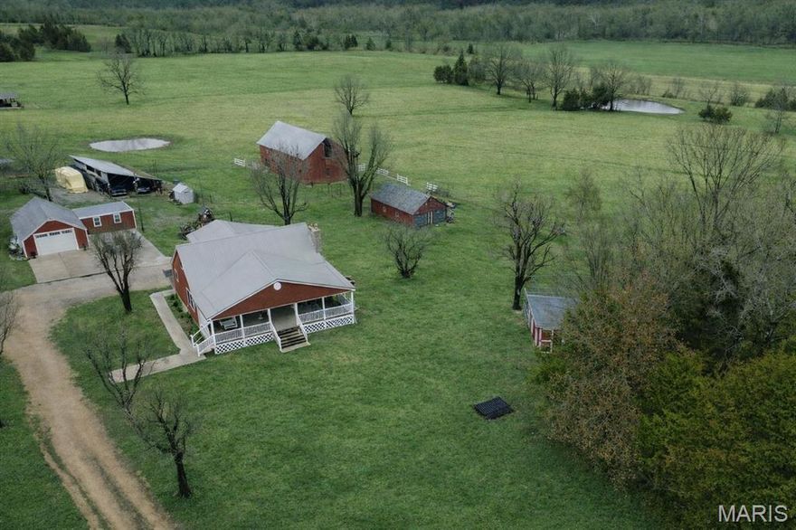 *3% from seller toward buyer's closing cost and prepaid expenses. Owning this stunning 14-acre private farmstead with equestrian potential, where timeless country charm meets modern comfort and functionality is more attainable than than you thought. 

For those seeking a true farm lifestyle, this property is fully equipped and ready to go. From the moment you arrive, you’ll be captivated by the rolling acreage, scenic views, and beautifully coordinated farmstead that create a picture-perfect setting in every direction. Properties like this are incredibly rare — a turnkey farm with acreage, multiple buildings, guest living space, and breathtaking views.

At the heart of the property sits a beautiful 2630 sq ft modern 4-bedroom, 2-bath farmhouse, thoughtfully updated inside and out. Designed for both comfort and entertaining, the home offers inviting living spaces and a warm, welcoming feel throughout. Start your mornings with coffee on the expansive covered front porch, and end your evenings relaxing on the large patio overlooking the peaceful countryside, while kids and pets enjoy the wide-open yard.

One of the property’s valuable features is the separate 1,100-square-foot guest house, offering exceptional flexibility. Complete with a full bathroom, kitchenette, laundry hookups, storage area, and ADA-accessible design, it is perfect for extended family, a private home office, studio, daycare, guest quarters, or even income-producing opportunities.

The land includes a classic red barn with stalls, milk house, and chicken coop, along with multiple additional outbuildings ideal for equipment, livestock, workshops, or hobby spaces. An extra-large garage provides abundant room for vehicles, tractors, and storage, with electricity and heating already in place in several buildings.  The 14 acres are fenced and cross-fenced, creating ideal pasture for horses, cattle, or hobby farming, making this an exceptional opportunity for equestrian enthusiasts or anyone seeking a functional working farm.

Adding to the property’s charm and curb appeal, the home, barn, and outbuildings are beautifully coordinated in color, creating a cohesive and picturesque farmstead that feels straight out of a countryside magazine.

This one-of-a-kind property truly must be experienced in person. Its beauty, character, and peaceful setting are something photos simply cannot capture. Duplicate property on MLS#26012466