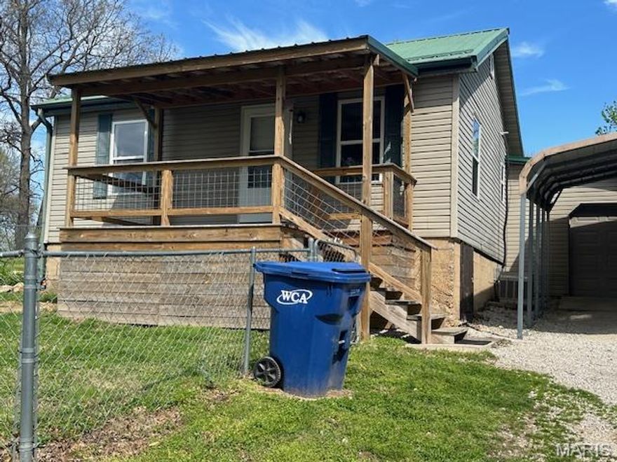 This property features a 2-bedroom layout, adaptable to 3 bedrooms, and includes 1 bathroom, benefiting from a prime corner lot location with proximity to local amenities. The interior flow starts with the dining room, which leads into the kitchen and then the living room. The hallway, accessible from the dining room, features the first bedroom to the left, the bathroom centrally located, and the primary bedroom to the right, which includes the option for a third bedroom or a spacious walk-in closet. The laundry area is situated beyond the walk-in closet, linking to the living room. The attached garage provides direct access to the living room and the fully fenced yard