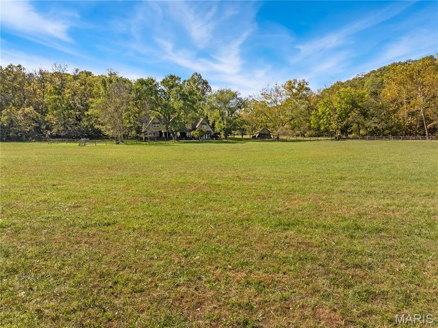 Just minutes from Camdenton, Willow Creek offers a rare blend of privacy, acreage, and luxury living on nearly 70 usable acres. Set along rolling pasture, mature timber, and a spring-fed creek, this property feels like a countryside estate with the convenience of being close to town. The main residence—originally reimagined from the studs in 1998–1999 and elevated again in 2005—combines timeless character with modern comfort and functionality.

Inside the 4,643 sq ft home, you’ll find 4 bedrooms, 3 full baths, and 2 half baths, arranged with a flow that supports everyday living as well as hosting. The chef’s kitchen is the anchor of the home, while multiple gathering spaces, thoughtful built-ins, and warm finishes create a refined but inviting atmosphere. The primary suite stands out with its own fireplace and his-and-her baths, offering the kind of privacy and comfort expected in a luxury estate.

A highlight of the property is the detached three-car garage with a fully finished loft apartment above—approximately 900 sq ft—perfect for extended stay guests, multi-generational living, a private office, or an income-producing rental. The flexibility and quality of this second living space significantly enhance the property’s long-term value.

Outdoor spaces are equally impressive. A stone patio, landscaped pond, waterfall, and a small bridge create a picturesque entrance that immediately sets the tone. The land is a mix of open and wooded ground, ideal for horses, hobby farming, recreation, or simply enjoying the scenery. A two-story horse barn with loft and two professional stalls anchors the equestrian amenities, while fenced pasture with freeze-proof waterers provides practical usability year-round. Additional historic outbuildings—including a charming granary—tie the property’s history into its present-day appeal.

What makes Willow Creek particularly special is its usability. The acreage is genuinely functional—beautiful, accessible, and diverse—with space for livestock, trails, gardens, equipment, or expansion. A spring-fed creek runs through the property, adding natural beauty and year-round water interest. Despite Zillow’s automated mapping, this property is NOT in a flood plain and includes a LOMA for peace of mind.

Luxury, acreage, history, location, and flexibility—Willow Creek brings all of it together. Properties of this scale and character so close to Camdenton rarely come available, and even more rarely in this condition.