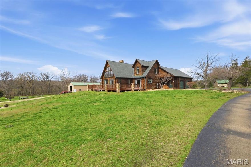 Escape to your own private river retreat with this stunning 3 bedroom 3 1/2 bath log home nestled on 28 m/l breathtaking acres. Surrounded by nature and offering unmatched privacy, this property is the perfect blend of of rustic charm and modern comfort. This property borders the Big River providing a beautiful place to swim and float! Step inside to find a warm and inviting family room anchored by a gorgeous stone pass thru fireplace, perfect for cozy evenings. The finished basement add a valuable living space, bonus bedroom and features its own striking stone fireplace. Enjoy the beauty of the outdoors with the oversized deck and large porch both offering beautiful view of the countryside. A serene pond enhances the landscape. This property also includes large outbuilding, perfect for storage, hobbies or workshop space.