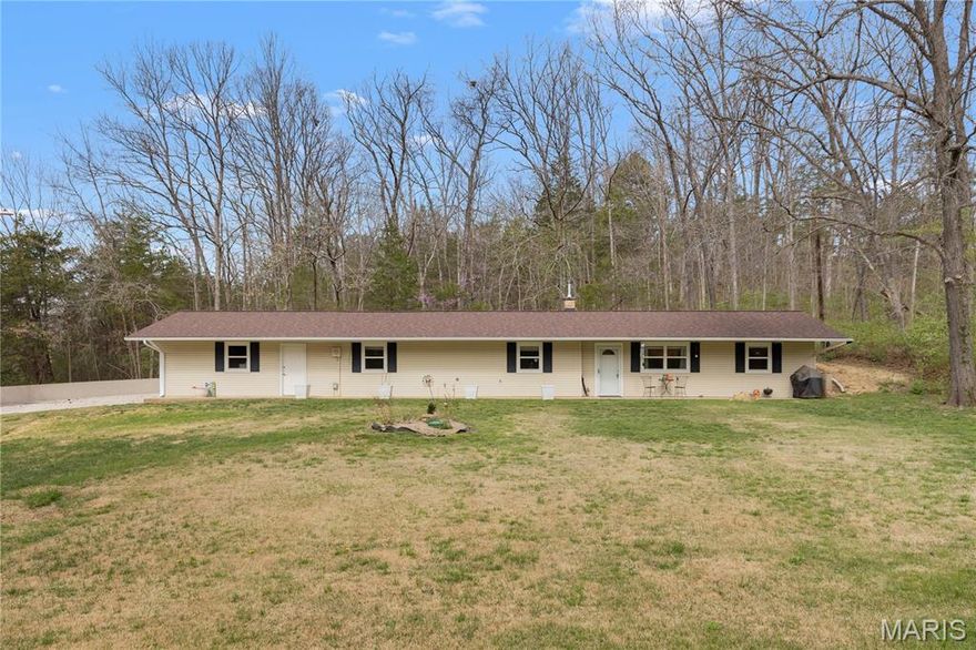 Updated ranch home on a secluded half acre. New gourmet kitchen (2023) with granite countertops and stainless steel appliances (refrigerator included). Open great room with electric heat stove and floor-to-ceiling brick mantel. Attached oversized two-car garage with shelving (included) & new garage door opener (2025 - $1k). New water heater and water softener (2025 - 6k). New luxury vinyl plank floors throughout (2023). New windows (2023). New front door (2023). New electrical system (2023). New architectural-shingle roof (2022). New gutters with screens (2025 - $2k). New exterior faucet (2025). Fresh paint throughout (2023). Certified for wood-burning stove.