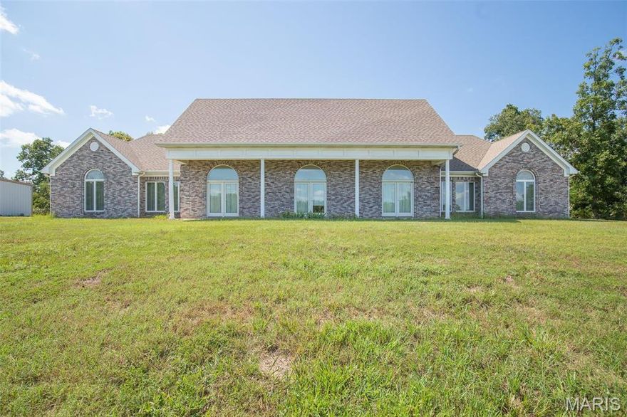 Breath-taking home on 6.5 acres (m/l) on top of the hill! You have to see this 3067 sq ft (m/l) ranch style home. Gorgeous home with a large 40x40 shop building. The home features some of the nicest cabinets you will find, granite countertops, high vaulted ceilings, two master bedrooms, (3 bedrooms total) and three bathrooms.  Travertine tile, custom built-in bookcases, Anderson windows and doors, gorgeous windows and window treatments. The designer hit every element on this home. It sits on top of the hill with a view for miles. Seller will leave all kitchen appliances. Everything on one level with no stairs! Quiet, private patio area with daily deer visits. (Also available with 64 acres (m/l) for $550,000. Ask for details.)