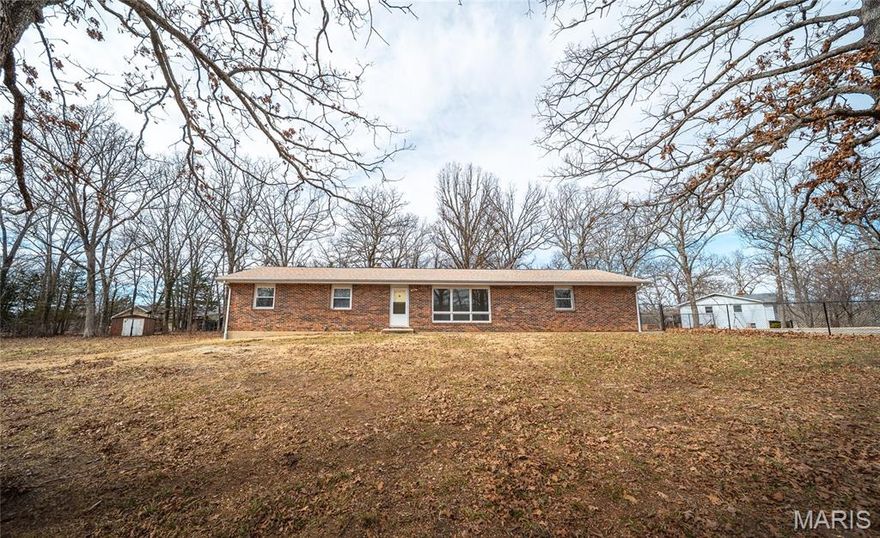 Say Hello to this Affordable & Polished Ranch Home on Almost an Acre Lot! Inside you will be Greeted by Stylish New Flooring, that can be found throughout most of the home, and Crisp White Walls, just waiting for your Personal Belongings. This Home Offers a Total of 3 Bedrooms, and 2 Full Bathrooms. With Convenience in Mind, the Primary Bedroom Presents a Full Attached Bathroom. Living Room is Nice & Roomy, with a Large Window for Natural Light to Delightfully Enter Through. Kitchen Presents a Wall Oven, Electric Cooktop, Dishwasher, and Refrigerator. Two Bonus Rooms pleasantly allow for the Choice of a Family Room, Dining Room, or an Office Area. Enclosed Patio grants Endless Opportunities for Birthday Parties or Gatherings. Extra Large Yard Provides Some Fencing in Place, and lots of room to run. Located at the End of the County Road & Just Outside the City Limits, experience the Luxury of Peace & Quiet. Adorned with Thoughtful Updates, and Room to Spread, This Property is a real Treasure!