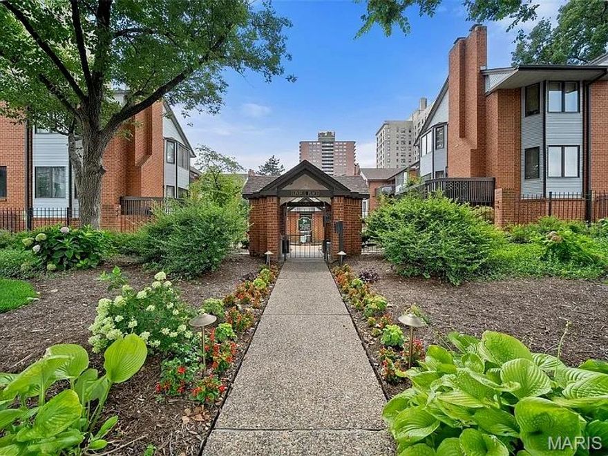 Sophisticated and stylish 2-bedroom, 2-bath Central West End condo. Enter the beautifully maintained complex through lush gardens, a sparkling pool, and landscaped walkways that lead to your home. Inside, a welcoming foyer sets the tone for the condo’s sleek, designer-inspired style. The open-concept living and dining spaces flow effortlessly and are complemented by a private balcony, creating the ideal setting for relaxing or entertaining. The recently updated kitchen features sleek custom cabinetry, solid-surface counters, and newer appliances, with a breakfast bar that connects seamlessly to the dining area. Just off the kitchen is a stylish bar area with under-cabinet lighting and glass-front cabinets—perfect for entertaining. The living room centers around a cozy wood-burning fireplace and opens to the front deck overlooking the pool—an inviting spot for morning coffee or evening cocktails. The spacious primary suite is a true retreat with its own private deck and an updated bath featuring a large vanity and tub/shower combination. A comfortable guest bedroom and hall bath complete the layout. New paint, wallpaper, lighting & fixtures throughout- no detail left untouched! Additional highlights include in-unit laundry, a two-car garage, extra storage, and newer HVAC ('24). Located just two blocks from Euclid and within walking distance of Forest Park, Lindell Place puts you at the center of the CWE’s best shops, restaurants, medical community and city living. Contact me (listing agent) to schedule your showing today!