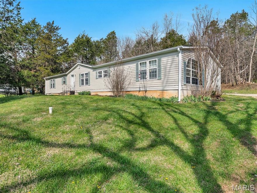 Welcome to 7711 Dittmer Road...your country home retreat!  This comfortable manufactured home has 4 bedrooms and 2 full baths with 2,052 square feet of living space on 3.64 acres.    This home has been permantly attached to a poured concrete foundation with a crawl space underneath.  The layout is fantastic with three bedrooms and a full bath on one end of the house and the master bedroom, second full bath (with double vanity sinks and a walk-in shower) on the other end.   A great layout for families...or an"in-law" type set-up.  The family room boasts triple-arched windows that flood the home with light!  The living room has a cozy wood-burning fireplace.  The kitchen has a nice breakfast bar for quick school day breakfasts and a center island for all those holiday dinner preparations!

The property boasts about an acre of frontage with the remaining acerage in a wooded lot behind the house.  There's a path that winds through the property for nature strolls or deer hunting during bow season.  You'll find a 2-car, covered carport and plenty of space for extra parking along the long gravel driveway.   The home has a well with a septic tank.   A new roof was added in 2019.  Come see for yourself how peaceful country living can be!