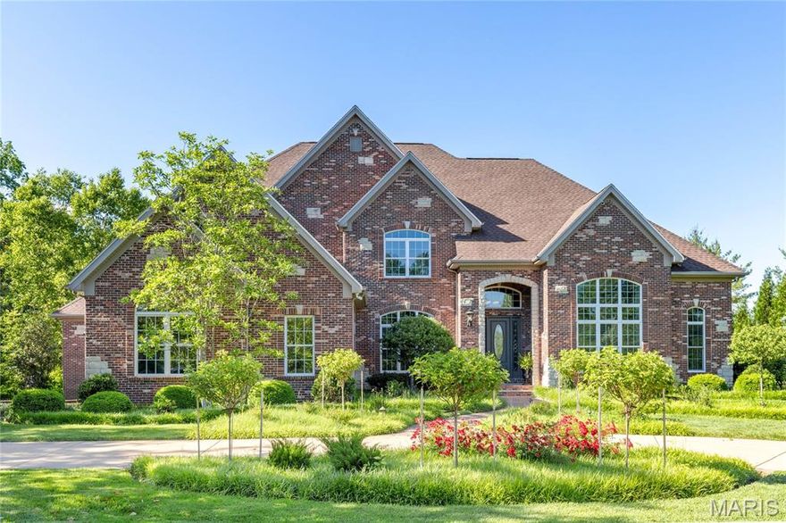 This spectacular estate home features exceptional craftsmanship & distinctive design elements throughout including oak hardwoods, soaring ceilings & detailed trim work. Gated drive leads to impressive 2-sty entrance with 8’ leaded glass door, barrel-vaulted foyer, private study, formal dining room with tray ceiling & arched entryways and stunning great room with floor-to-ceiling fireplace flanked by 2-sty windows. Culinary enthusiasts will love the kitchen designed by Mosby Building Arts with custom cabinetry, quartzite countertops, premium stainless-steel appliances, 11’ center island & butler’s pantry. Light-filled breakfast room & hearth room with stone fireplace provide a welcoming gathering place. Coffered primary bedroom suite offers an appealing retreat with wide bay window, luxury bath with shower spa & freestanding tub & adjacent screened porch. The 2nd floor extends the living quarters with 3 additional bedrooms, 1 with ensuite bath & 2 with Jack n’ Jill bath. Lower-Level entertainment space includes recreation room with crescent wet bar, family room with fireplace, office, guest suite & half bath. Sliding glass door opens to outdoor living area with deck, screened & covered patios & pergola with full-height fireplace plus resort style pool with spa.