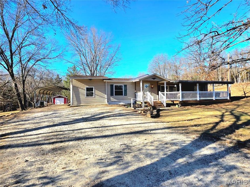 Enjoy Country Living on this private, nearly 16.8 acres. Located just a short distance out of town, this may just be what you're looking for!  With one-level living, this 4-bed, 2-bath home has been updated and is looking for someone to call it "Home".  Could it be you?  BIG covered porch stretches along the front, a great place to sit a spell and enjoy the view.  Now, step inside and take a look.  Spacious Living Room with wainscotted walls is perfect for relaxing and entertaining.  Dining Area is located just off the Living Room and flows effortlessly into the large Kitchen.  With cabinets wrapping around three walls, there's plenty of storage room!  There's a big detached Carport, as well as a 10' x 20' Shed and a 14'6" x 20' building waiting to be your Office or see where your imagination takes you. Also the seller has already started the fencing for you. Conveniently located just west of city limits and not far from I-44.  Don't Delay! Look Today!