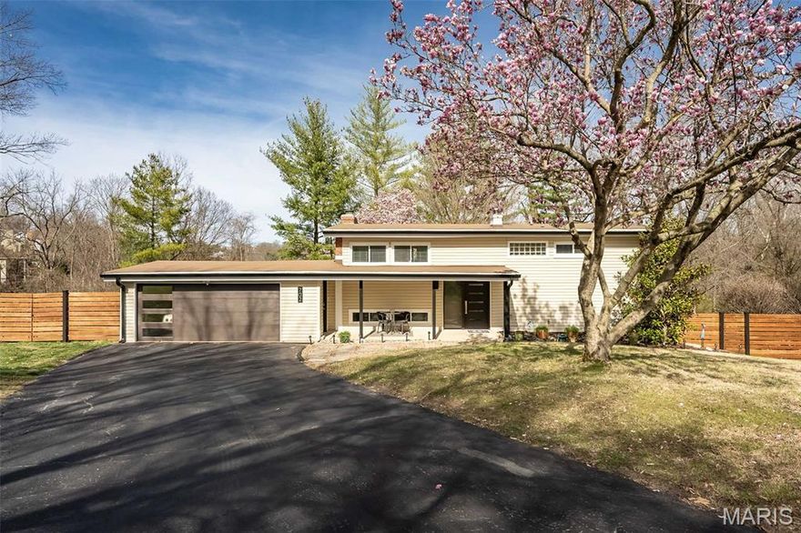 Welcome to this Barrett Brae gem, nestled in one of St. Louis’s premier mid-century neighborhoods, where homes reflect the timeless influence of Frank Lloyd Wright-inspired architecture. This is a rare opportunity to own a truly special property in a neighborhood recognized by the Kirkwood Landmarks Commission and Architectural Review Board as a historic area of distinction. From the moment you arrive, the home’s thoughtful mid-century modern design is on full display. Exterior highlights include newer entry and garage doors with clean, linear detailing, a glass sidelight, complementary lighting, floating pavers set in stone, and a custom-built cedar privacy fence. The front porch offers the perfect place to relax, enjoy the landscaping, and sip your morning coffee. Inside, the entry welcomes you with a mid-century modern-inspired cable stair railing and open views to both levels of the home. The lower level impresses with its open floor plan, seamless flow, and Japanese seagrass laminate flooring. A trio of extra-wide Pella sliding glass doors along the back of the home fills the space with abundant natural light and connects the indoors to the natural beauty outside. The living room features a wood-burning fireplace with a painted brick surround, flanked by built-ins perfect for displaying books, art, and treasured collections.
The spacious dining room easily accommodates a large table for gatherings and entertaining. In the kitchen, you’ll find stainless steel appliances, including a five-burner gas range, custom white cabinetry with frosted glass accents, modern tile, quartz countertops, a breakfast bar with seating and access to the side yard. Storage is exceptional, with two double-wide closets, including a pantry, both featuring frosted glass doors in keeping with the home’s design aesthetic.
Also on the main level is an updated full bath with a walk-in shower, a laundry closet with washer and dryer included, and a carpeted bonus room ideal for a home office, gym, or guest bedroom. Upstairs, you’ll find a cozy family room, a spacious primary bedroom with a large walk-in closet and a vanity niche illuminated by natural light, plus two additional bedrooms with generous closet space. A beautifully updated bathroom features a double vanity, hexagonal tile flooring, and a spa-like wet room with a custom shower and large soaking tub. Additional features include wood flooring, neutral decor, and ceiling fans in all bedrooms. The oversized front driveway leads to a two-car garage with an attached storage room, while two additional outdoor sheds provide even more storage space. Set on a spectacular .53-acre lot, the property offers rear fencing and backs to trees, the MO Pacific RR  and the open fairway of hole #4 of the Greenbriar Hills Country Club. The expansive patio provides ample room for lounging and entertaining, with beautiful views surrounded by nature.
An extensive list of updates is available in the attachment and includes the roof, gutters, 200-amp overhead electrical service, and chimney flue restoration. Located in the highly rated Kirkwood School District, which has earned an A+ grade from Niche and is consistently ranked among the best school districts in Missouri, this home is also just minutes from shopping, dining, and easy access to I-270, I-44, I-40, and Route 121. A must-see home that truly will not disappoint.