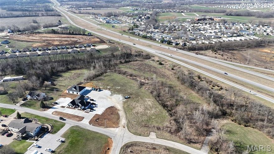 Prime 1.89+/- acre commercial lot (Lot 2) located in Moscow Mills, offering an excellent opportunity for development in a growing area. Situated within a Business Park / Industrial Park setting, this property is ideal for a variety of commercial or light industrial uses. The lot provides ample space for a building, parking, and operational needs while still allowing room for future expansion. Its convenient location offers easy access to surrounding communities and major roadways, making it an attractive location for businesses looking to establish or grow in the area. With continued development and demand for commercial space in Moscow Mills, this property presents a great opportunity for investors, developers, or business owners seeking a strategic location in a thriving commercial corridor.