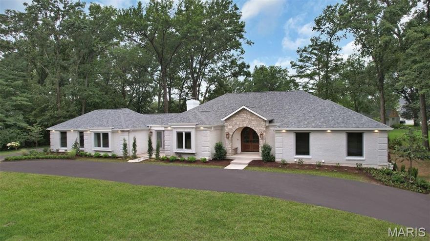 Experience refined Town & Country living in this sprawling, fully reimagined ranch by Callahan Custom Homes. Boasting 6 bedrooms, 5 full and 2 half bathrooms, this estate seamlessly blends timeless elegance with modern sophistication. The open-concept design is anchored by 12" wide white oak floors, custom arched tray ceilings, and abundant natural light through new Anderson windows. A true chef’s kitchen stuns with custom cabinetry, quartzite countertops, and an oversized 12’ waterfall island, complete with Monogram, Dacor, and other luxury appliances. The great room features a striking fireplace flanked by arched built-ins, a custom illuminated bar, and a 12’ sliding door opening to the covered outdoor living area with wood ceiling, fireplace, and privacy landscaping. The luxurious primary suite includes a spa-style bath with heated tile floors, freestanding soaking tub, and a custom walk-in wet room. A custom wine cellar, gym with steam shower, soundproofed theater zone, and epoxy-finished garage add unmatched comfort and utility. Every inch of this home—from the all-new mechanical systems to the designer finishes—reflects superior craftsmanship. Located within minutes to everything, this rare offering redefines modern luxury living.