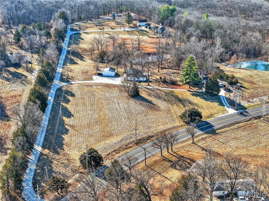Two homes, detached garage and a small pond on 6.57 Acres of land in unincorporated St Charles County with no HOA! An investor's dream or the perfect property for an owner to live in one house and rent out the other. There are so many possibilities with this property. Build a Shouse, detached building or even a new custom home while having a current home to live in. One home is currently rented on a month-to-month basis and needs some updating. The other home has some updates with fresh paint, newer vaulted room addition off the back with a mini split hvac. Both homes have older buried septic tanks and will need updated. The current owner is selling as is and will make no repairs so it will be the responsibility of the buyer to update septics and any other repairs. Both homes are on public water. There are a total of 3 tax id’s and 2 addresses per St Charles County. 818 and 824 W Hwy D Wentzville Mo 63385.