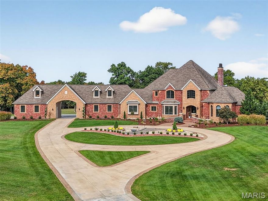 Extraordinary one of a kind 39+/- acre luxury estate offering exceptional privacy, water features, and true resort-style living, with additional acreage available for purchase. Designed for legacy ownership, multigenerational living, or a private retreat, this property combines refined architecture with unmatched amenities.
The main residence showcases exceptional architectural detail throughout, beginning with a grand two-story great room featuring extensive custom millwork, hardwood flooring, and a beautiful fireplace framed by an ornate, furniture-grade wood surround. A dramatic entertainer’s bar anchors the space, highlighted by a custom wood canopy suspended by decorative metal chains. Adjacent, the hearth room offers a striking floor-to-ceiling fireplace and walls of windows overlooking the grounds.
The gourmet kitchen features furniture-grade cabinetry, granite countertops, a large center island, warming drawer, and seamless flow to the hearth and breakfast rooms. The kitchen walks out to a massive deck with sweeping views of the lake and pool—ideal for entertaining or everyday enjoyment.
Just off the foyer, a private main-level executive office includes custom built-ins, rich wood detailing, and motorized window shades, providing a quiet professional workspace or refined retreat. The main-level owner’s suite offers private deck access, a spa-style bath, and dual walk-in closets.
The upper level includes two private bedroom suites, each with en-suite baths and walk-in closets with built-in's, along with a loft overlooking the great room.
The mostly finished lower level is designed for both comfort and entertaining, offering a second full kitchen, family room with stone fireplace, recreation room with an additional fireplace —bringing the home to a total of four fireplaces, dedicated media/theater room, additional bedroom suite, 5th  bedroom currently used as a workout room, and extensive storage.
Notable systems and upgrades include a professionally installed whole-home and outdoor audio system, upgraded wireless security system, climate-assisted wine storage with wood racking, energy-efficient geothermal heating and cooling, solar system, radiant basement floors, and geothermal pool heating. Underground double-wall fuel storage tanks are professionally installed to DNR standards, providing enhanced safety and emergency preparedness.
The outdoor living spaces are truly resort-caliber, featuring a saltwater pool, expansive hardscaping, built-in fire pit, covered patio with outdoor kitchen, mature landscaping, a private lake, two additional ponds, and expansive grounds ideal for recreation and relaxation.
The property also includes a substantial brick carriage house with a massive workshop, main-level entertainment area with full bath, and finished living quarters above—perfect for guests, hobbies, or multigenerational use. The main residence offers five heated garage bays, completing this exceptional offering.
A rare opportunity to own a luxury estate of this caliber, offering privacy, flexibility, and enduring value.